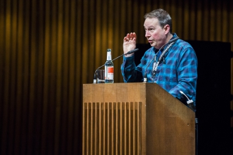 Picture of Ryan Bishop introducing the Keynote Conversation "Anxious to Share"