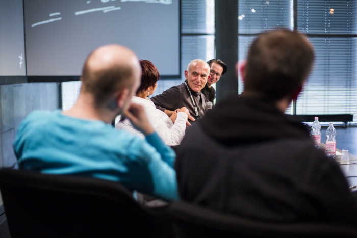 Picture of Nicholas Anastasopoulos (center) at the hybrid event "Re-examining Global.Ports"